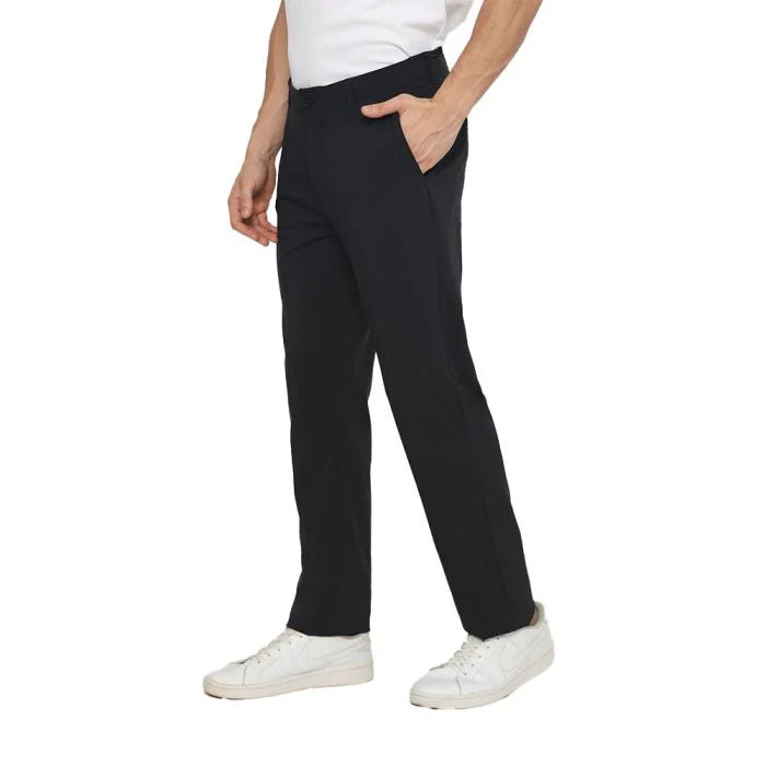 Person wearing black pants and white shoes on a white background