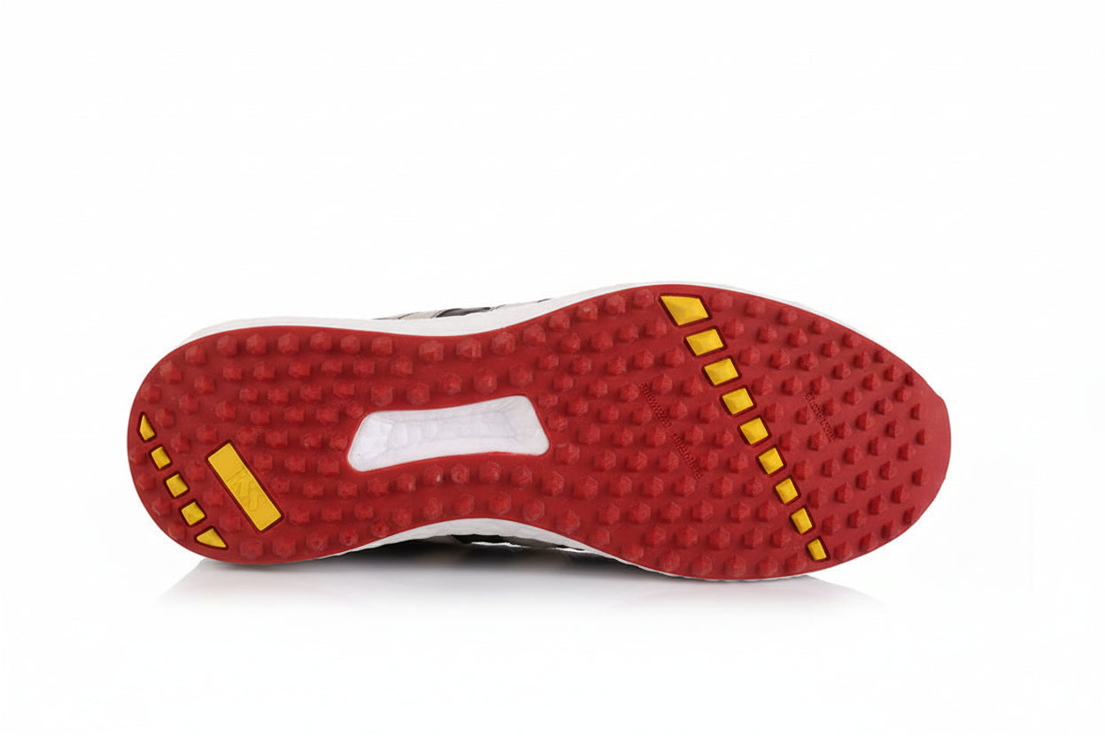 red and yellow sole of a shoe on a white background