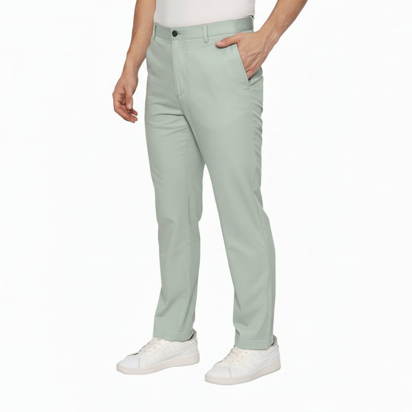 Light green pants worn by a person on a white background
